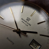 A close up, macro shot, of a vintage Marvin Revue mens watch with a date window at 3 o'clock and a highly reliable ETA 555 411 quartz movement, beating underneath.
